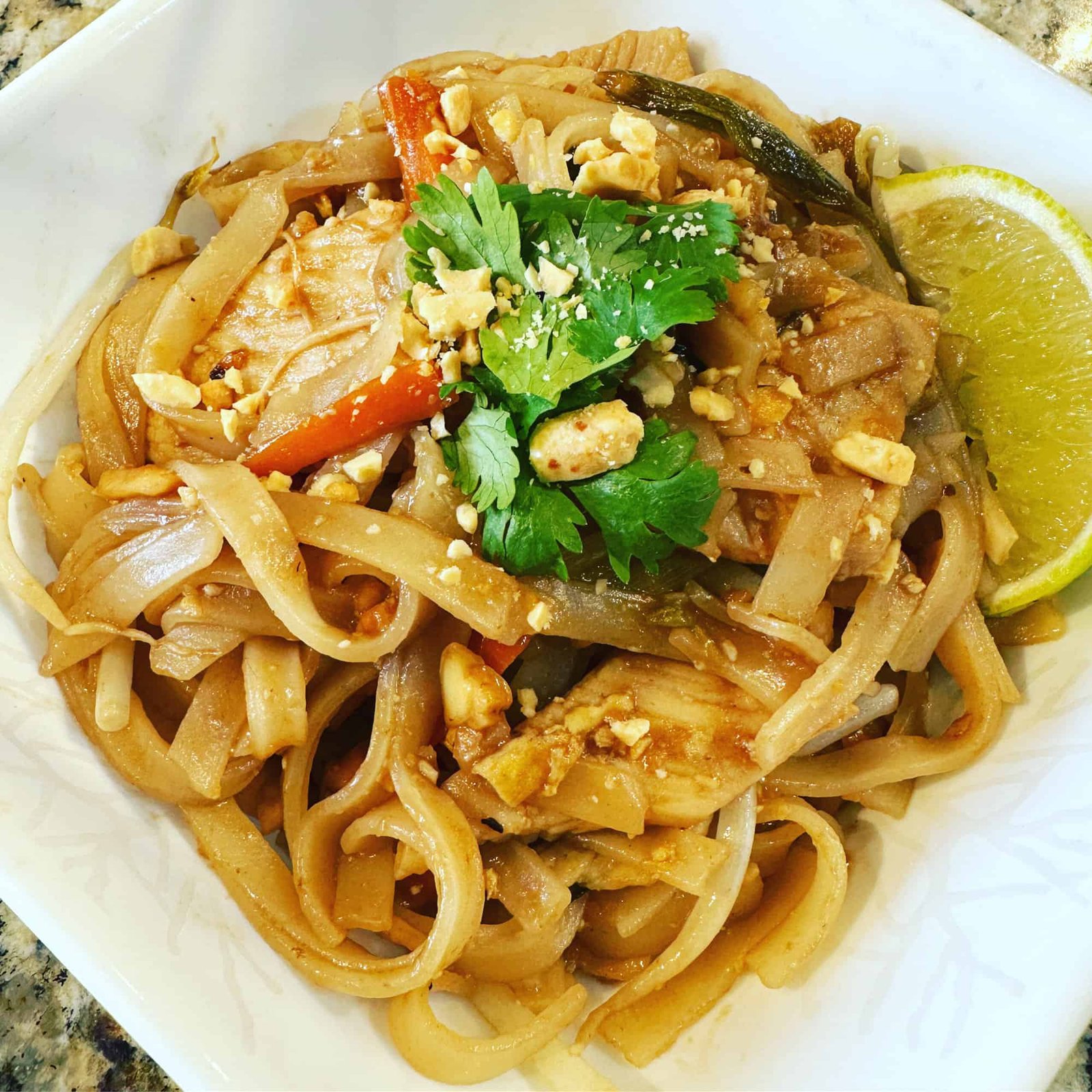 What are the essential ingredients in authentic Thai Pad Thai?