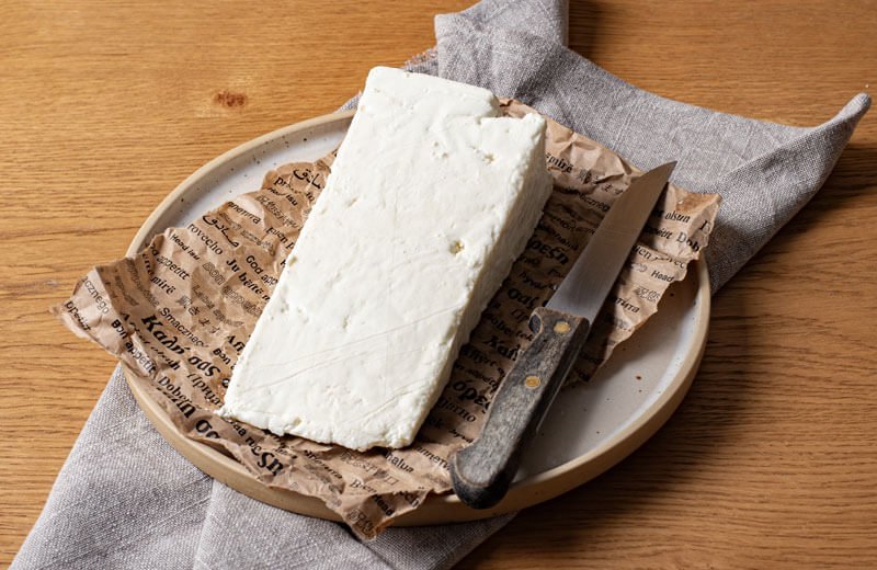 Why do Greek recipes feature feta cheese prominently?